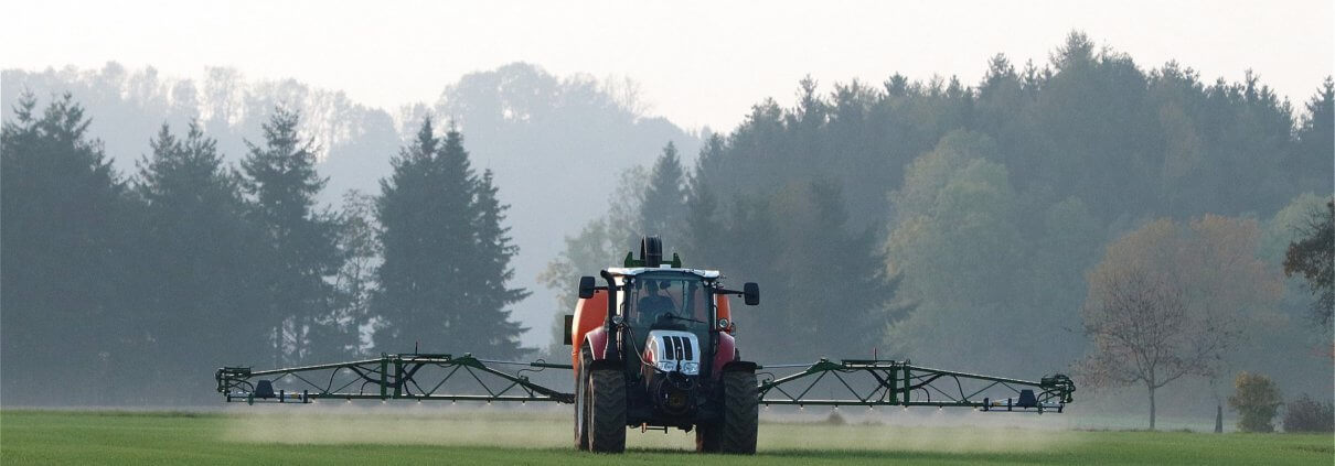 Tractor spraying field