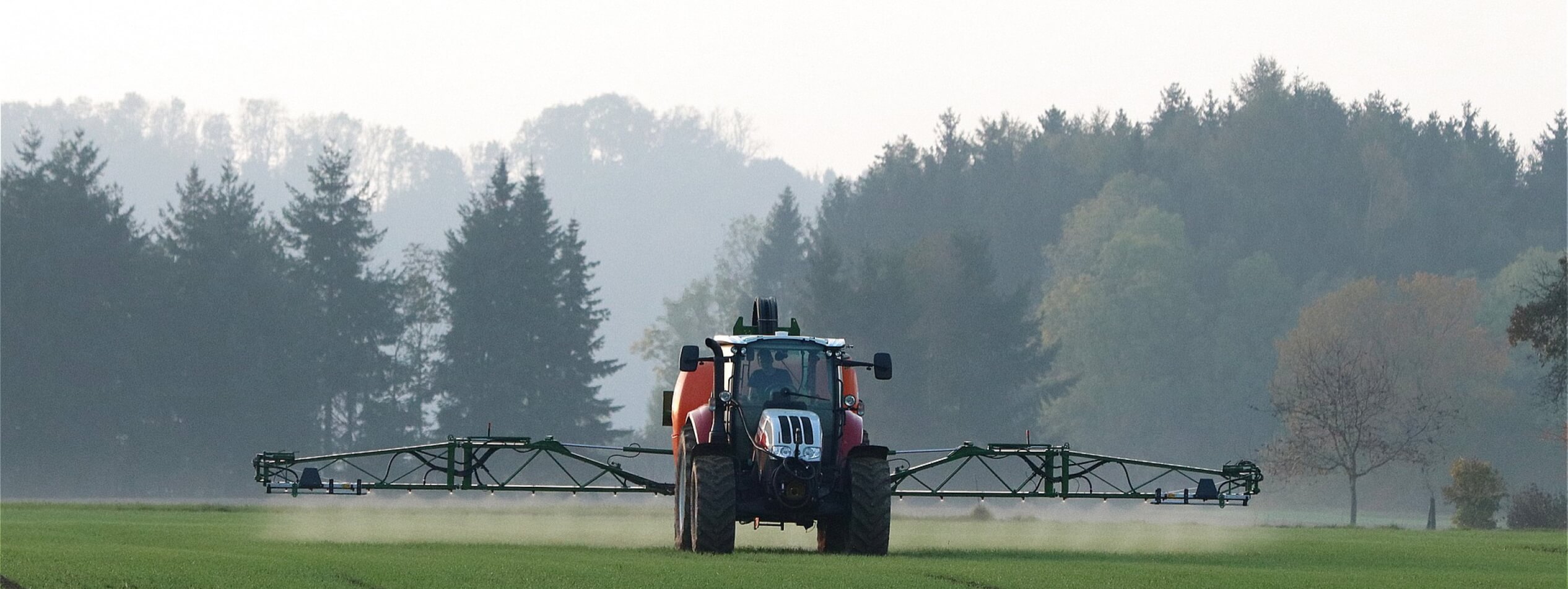 Tractor spraying field